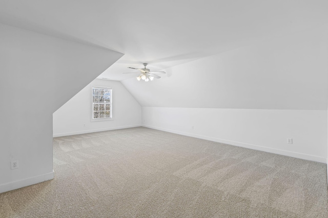 bonus room featuring baseboards, ceiling fan, carpet flooring, and vaulted ceiling