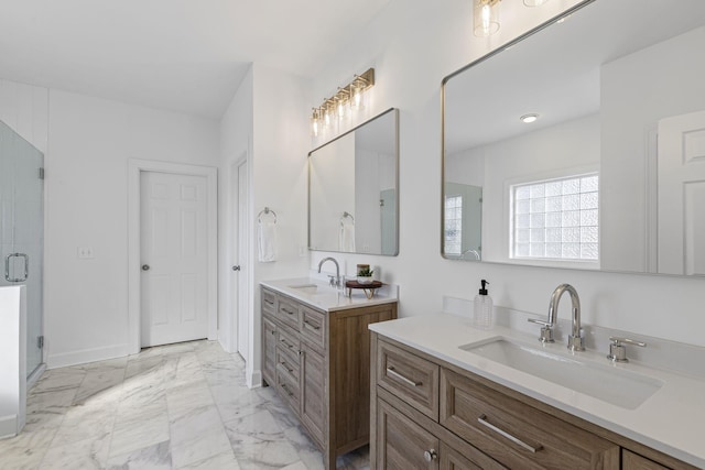 bathroom featuring a sink, two vanities, marble finish floor, and a stall shower