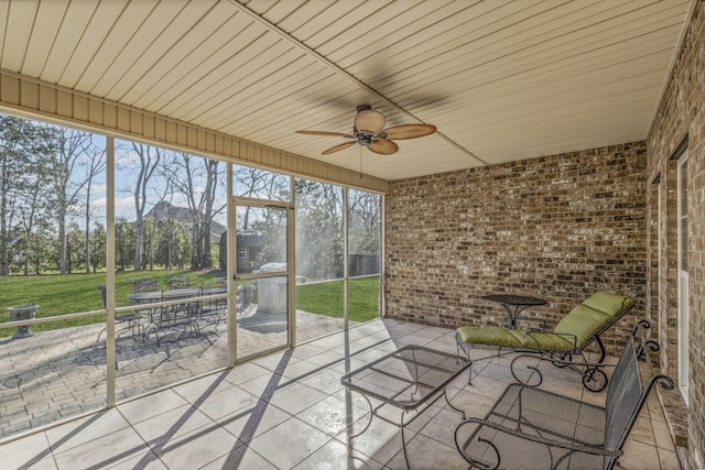 unfurnished sunroom featuring ceiling fan and wooden ceiling