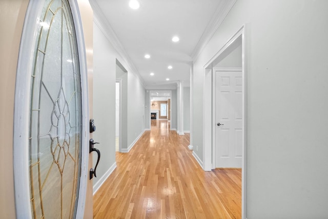 hall featuring crown molding, light wood-style flooring, recessed lighting, and baseboards