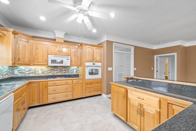 kitchen with a sink, white appliances, dark countertops, and a ceiling fan