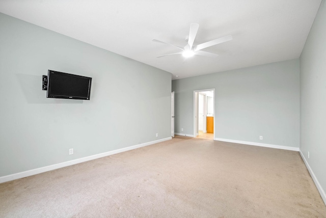 empty room with light carpet, baseboards, and a ceiling fan