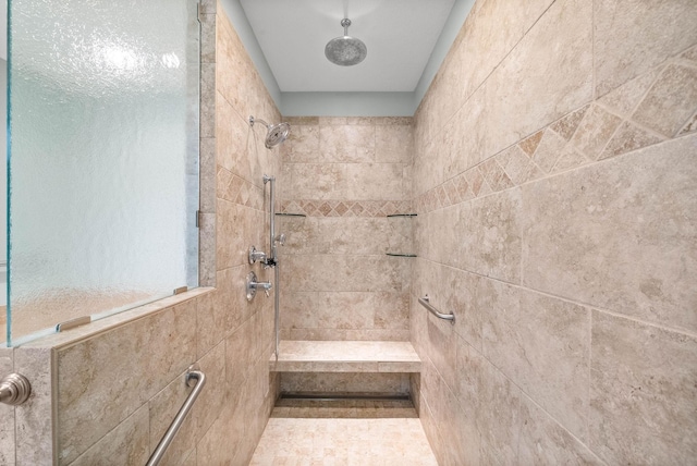 full bath with a tile shower