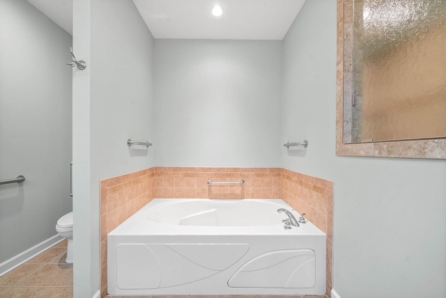 full bathroom with tile patterned floors, toilet, and a garden tub