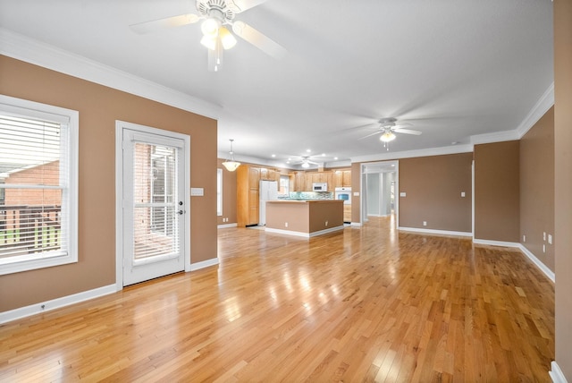 unfurnished living room featuring baseboards, light wood-style floors, ceiling fan, and ornamental molding