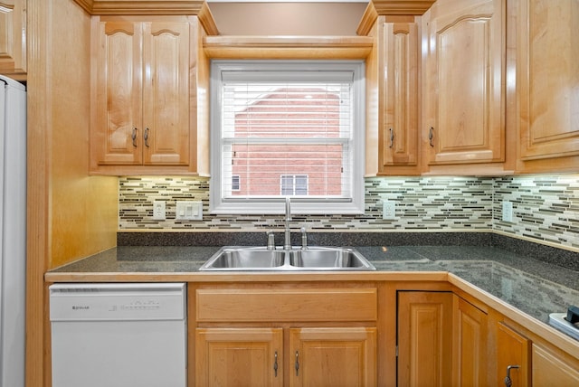 kitchen with a sink, decorative backsplash, white dishwasher, and light brown cabinets