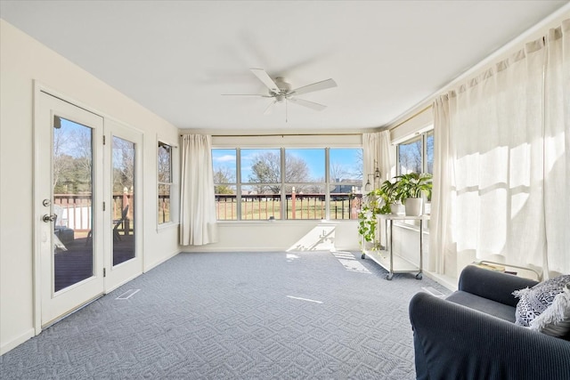 sunroom / solarium featuring visible vents and a ceiling fan