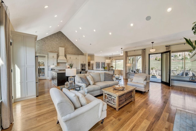 living room with recessed lighting, high vaulted ceiling, and light wood finished floors