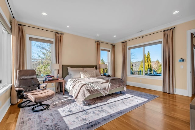 bedroom featuring recessed lighting, multiple windows, and wood finished floors