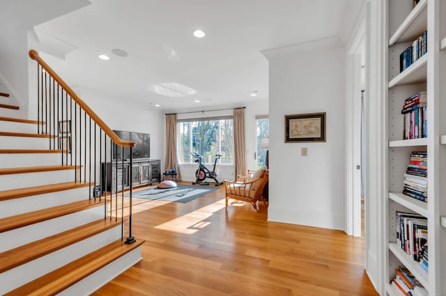 stairs with recessed lighting, baseboards, and wood finished floors