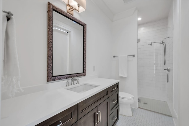 bathroom featuring tile patterned flooring, a shower stall, toilet, and vanity