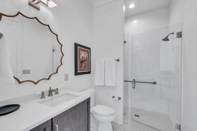 bathroom featuring vanity, a shower stall, toilet, and tile patterned flooring