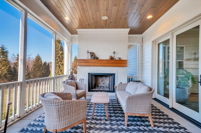 sunroom with an outdoor brick fireplace, wood ceiling, and a healthy amount of sunlight