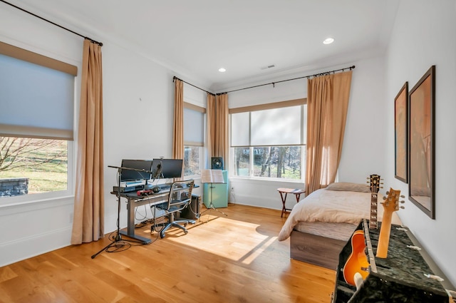 bedroom with recessed lighting, visible vents, and wood finished floors