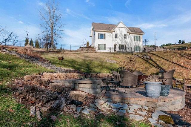 back of property with a yard, a patio, and fence