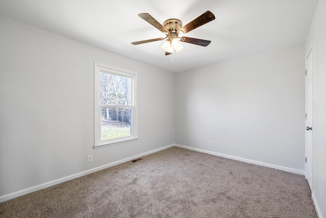 unfurnished room featuring visible vents, baseboards, a ceiling fan, and carpet floors