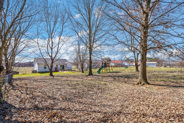 view of yard with a playground and fence