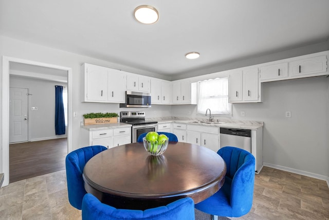 kitchen featuring white cabinets, appliances with stainless steel finishes, and a sink