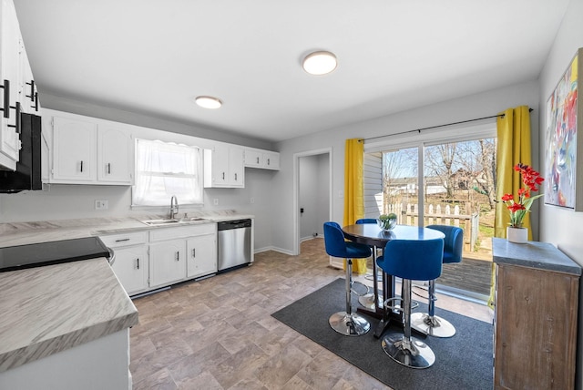 kitchen with a sink, light countertops, white cabinetry, and stainless steel appliances