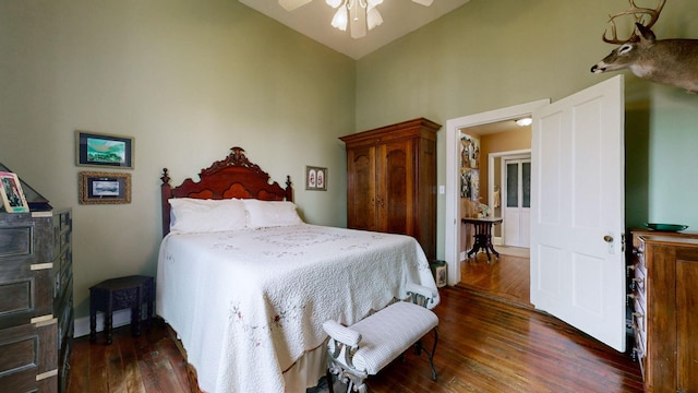 bedroom featuring high vaulted ceiling, wood finished floors, and a ceiling fan