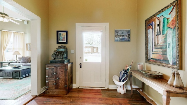 entryway featuring baseboards, ceiling fan, and wood finished floors