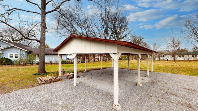 view of patio / terrace featuring gravel driveway and a detached carport