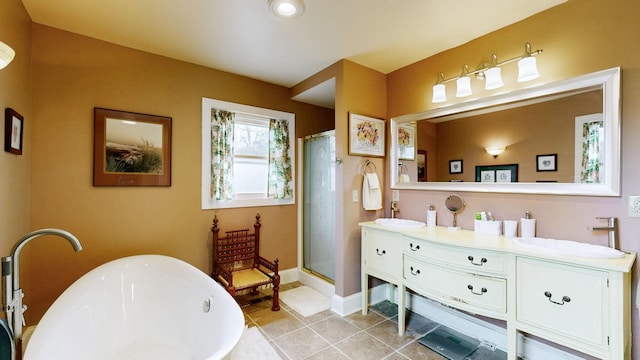 full bath with a shower stall, a freestanding tub, double vanity, and a sink