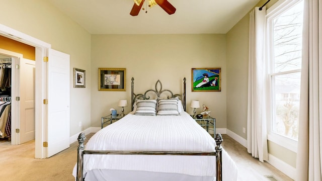 bedroom featuring ceiling fan, visible vents, baseboards, and light carpet