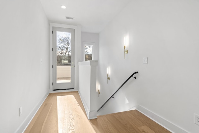 entryway with light wood-type flooring, visible vents, and baseboards