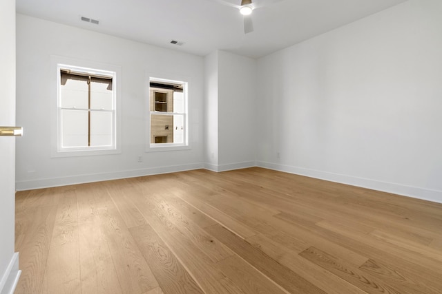 unfurnished room featuring visible vents, baseboards, light wood-style flooring, and a ceiling fan