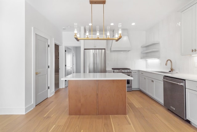 kitchen with a sink, open shelves, a center island, appliances with stainless steel finishes, and custom exhaust hood