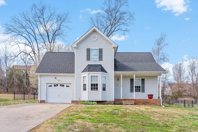 traditional-style home featuring driveway, a front yard, a garage, and roof with shingles