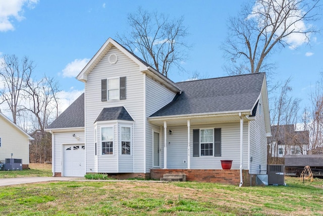 traditional home featuring a front yard, an attached garage, central AC unit, and roof with shingles