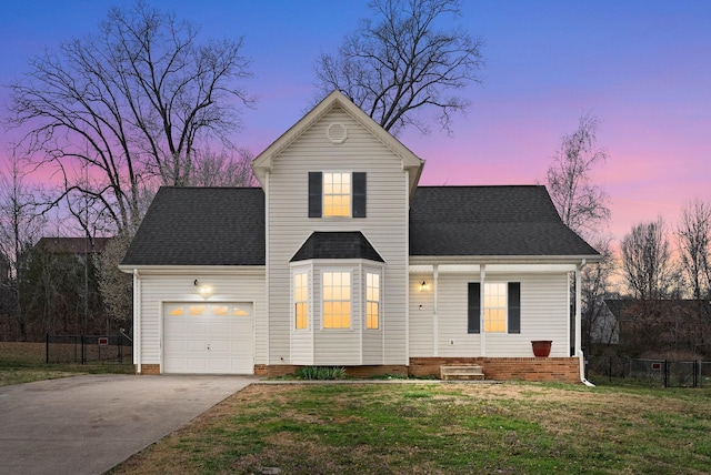 traditional home featuring fence, a garage, driveway, and roof with shingles