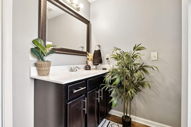 bathroom with vanity and baseboards