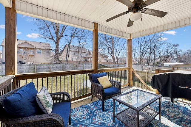 deck featuring a residential view, area for grilling, a fenced backyard, and a ceiling fan