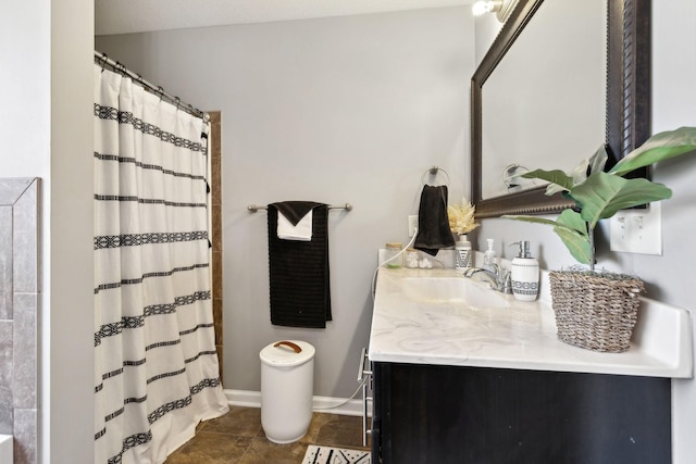 bathroom featuring vanity, a shower with curtain, and baseboards