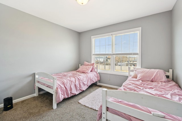 carpeted bedroom featuring baseboards