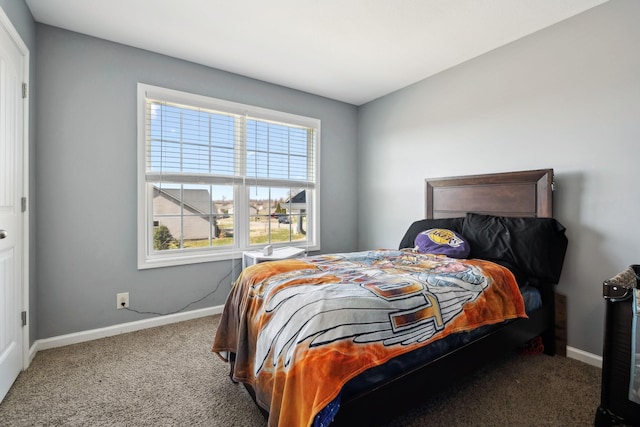 bedroom featuring carpet flooring and baseboards