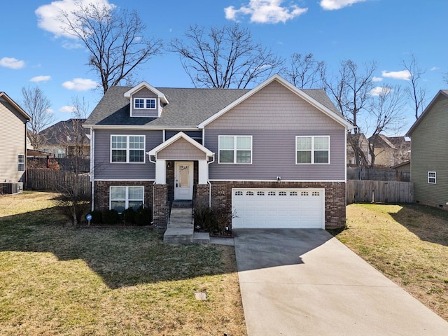 bi-level home featuring brick siding, fence, a front yard, a garage, and driveway