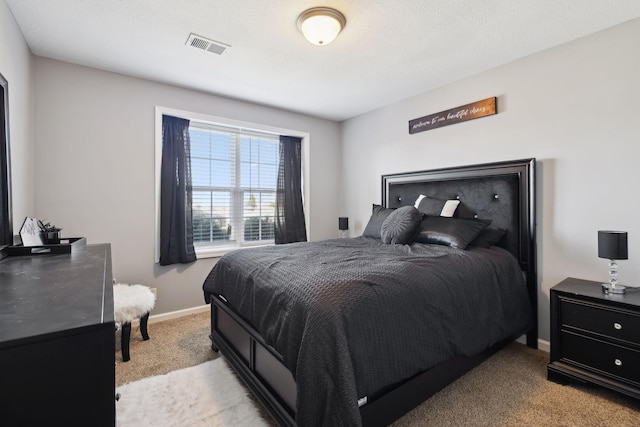 bedroom with visible vents, baseboards, and light colored carpet