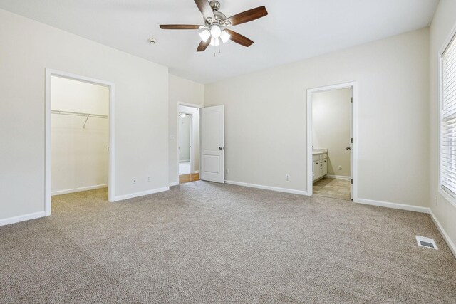 334 Idaho Springs Rd, Clarksville, TN 37043 - unfurnished bedroom with visible vents, baseboards, a spacious closet, a closet, and light colored carpet