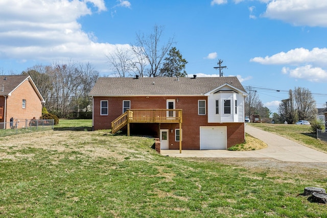 334 Idaho Springs Rd, Clarksville, TN 37043 - back of house with an attached garage, a lawn, brick siding, and a wooden deck