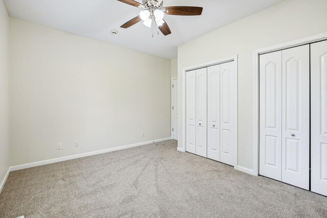 334 Idaho Springs Rd, Clarksville, TN 37043 - unfurnished bedroom with baseboards, multiple closets, a ceiling fan, and carpet flooring