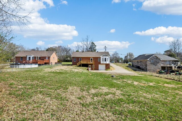 334 Idaho Springs Rd, Clarksville, TN 37043 - view of yard featuring a garage, driveway, fence, an outdoor pool, and a wooden deck