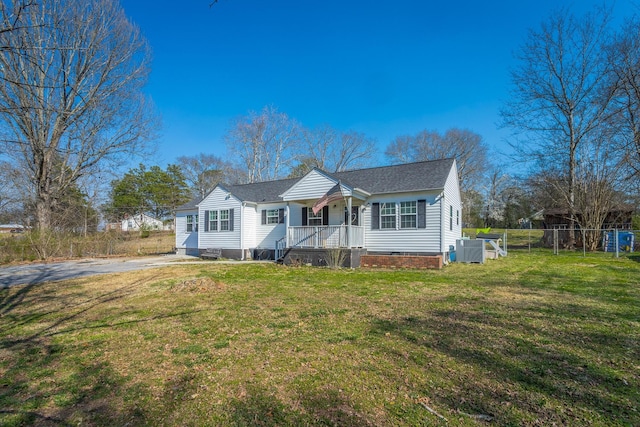 bungalow with a front lawn, fence, roof with shingles, cooling unit, and crawl space