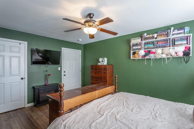 bedroom with baseboards, a ceiling fan, and dark wood-style flooring