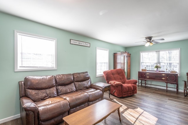 living area featuring a ceiling fan, wood finished floors, and baseboards