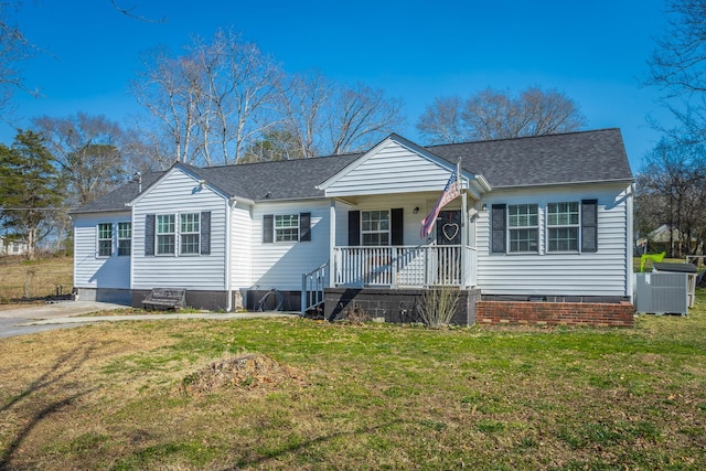 view of front of house with crawl space, cooling unit, and a front lawn