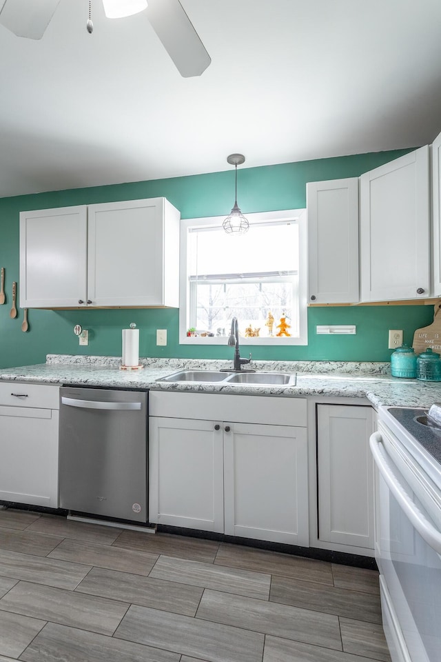 kitchen featuring a sink, decorative light fixtures, stainless steel dishwasher, white electric range oven, and white cabinets